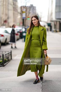 Gala Gonzalez wears a green long fluffy coat, a wool striped dress,... Nachrichtenfoto - Getty Images Gala Gonzalez, Fluffy Coat, Print Socks, Black Leather Shoes, Orange Bag, New York Fashion Week, New York Fashion, Striped Dress, Leather Shoes