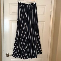 Flowy Navy And White Striped Maxi Skirt. Never Worn, In Excellent Condition! White Maxi Bottoms For Day Out, White Maxi-length Bottoms For Day Out, White Maxi Length Bottoms For Day Out, Casual Maxi Length Bottoms For Day Out, White Maxi Length Summer Bottoms, Chic Wide Leg Maxi Skirt For Vacation, Spring Striped Maxi Skirt With Lining, Striped Maxi Skirt With Lined Skirt For Spring, Striped Flared Skirt For Summer