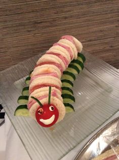 a caterpillar made out of cucumbers and other food on a plate