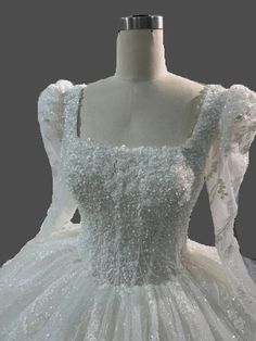 a white ball gown on a mannequin headdress with sequins