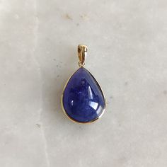 This stunning Pendant is set in 14k Solid Yellow Gold with Natural Tanzanite with utmost precision. It is a unique gemstone Pendant for nearly every occasion and is completely hassle-free jewelry. ITEM DETAILS: * CENTER GEM: Tanzanite * GEM SIZE: 13X18mm * GEM SHAPE: Pear * Gem WEIGHT: 14.55 carats * Gold Purity: 14KT * Gold Weight: 0.65 gram * Total Weight: 3.56 gram The Gold purity is guaranteed and it comes with authentic 14KT gold hallmark. Since my items are handmade, they are absolutely nickel and lead free. CUSTOMIZATION: * Gemstone customization is available and it can be substituted with a gem of your choice. Kindly message me for the same. PACKAGING * The Pendant comes with layers of safe and secure wrapping along with Free handmade jewelry box with every purchase. ➡️Head to thes Gold Tanzanite Teardrop Jewelry, Gold Tanzanite Pendant Jewelry, Tanzanite Teardrop Gemstone Jewelry, Tanzanite Oval Pendant Necklace With Gemstone, Tanzanite Gemstone Round Pendant, Tanzanite Pendant, Handmade Jewelry Box, Tanzanite Jewelry, Bezel Pendant