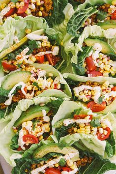 lettuce, corn and tomato salad with dressing on a platter ready to be eaten