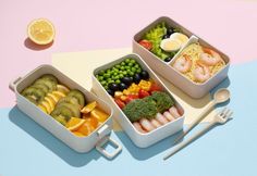 three containers filled with different types of food on top of a blue and pink surface