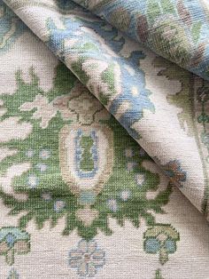 an upholstered fabric with blue and green floral designs on the outside of it