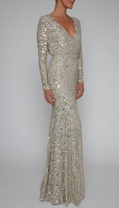 a woman in a long dress with sequins on it