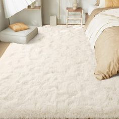 a bedroom with a large white rug on the floor