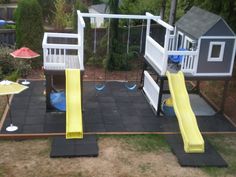 a play area with slides and swings in the backyard