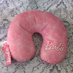 a pink donut shaped pillow sitting on top of a bed