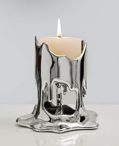 a silver candle holder sitting on top of a table