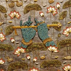 an intricately designed wall hanging with flowers and birds