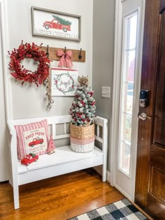 the entryway is decorated for christmas with wreaths and other holiday decorations on display