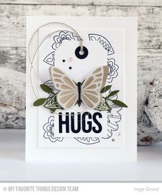 a card with a butterfly on it and the words hugs written in black, white and green