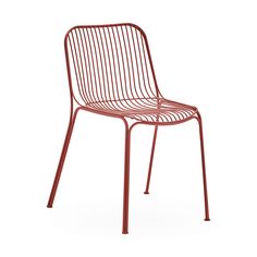 a red metal chair sitting on top of a white floor