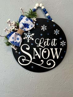 a sign that says let it snow hanging on the wall