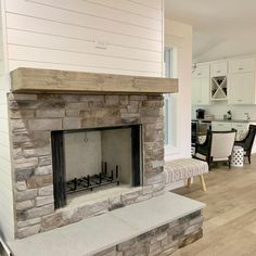 a living room with a fire place sitting on top of a hard wood floor