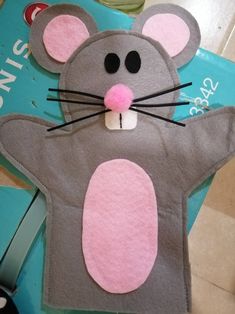 a mouse made out of felt sitting on top of a table