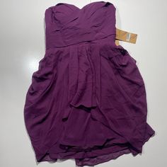 a purple dress is laying on the floor