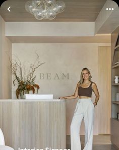 a woman standing in front of a white counter