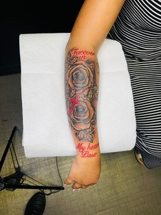 a woman with a rose tattoo on her arm