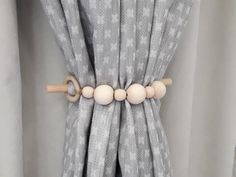 a curtain with wooden beads hanging from it's side