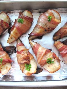 bacon wrapped potatoes are on a baking sheet