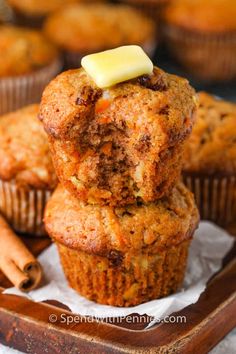 carrot muffins stacked on top of each other with cinnamon sticks in the background