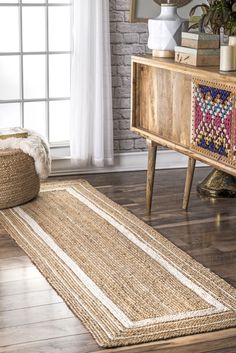 a rug on the floor in front of a window