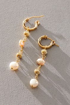 So stunning, these dainty drop earrings feature classic hoops and a shiny 14k gold-filled finish with genuine freshwater pearls. **Features:** Handmade, drop silhouette, classic hoops with a clasp closure, genuine freshwater pearls, 56mm length **Why We ❤ It:** These earrings are a beautiful addition to any jewelry collection. | Atma Prema Drip Pearl Earrings at Free People in White Recycled Earrings, Silver Chandelier Earrings, Ear Chain, Heart Shape Box, Knot Earrings, Stud Set, Accessories Jewelry Earrings, Brass Earrings, Gold Earrings Studs