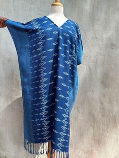 You will look fabulous in this truly unique hand made kaftan from hand woven (with hand woven pattern!) and hand dyed thread. The kaftan feels as good as it looks with soft and graceful drape. Pefect for evening wear, events and out and about it is made with care and long lasting quality. Traditional Blue V-neck Kaftan, Blue Ikat Print Kaftan For Summer, Traditional Blue Ikat Print Dress, Indigo Bohemian Dress With Natural Dye, Summer Blue Ikat Print Kaftan, Bohemian Blue Kimono With Natural Dye, Traditional Handmade Kaftan With Kimono Sleeves, Blue Bohemian Kimono With Natural Dye, Traditional V-neck Kaftan With Ikat Print