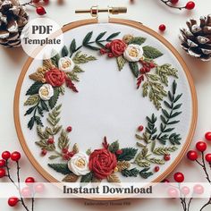 an embroidery pattern with red and white flowers on it, surrounded by pineconis