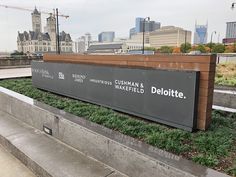 a sign that is sitting on the side of a road in front of some buildings