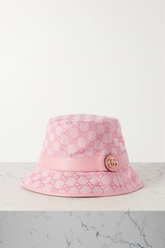 Bucket hats are part of the '90s revival that shows no sign of slowing. This one from Gucci comes in lightweight but hard-wearing cotton-blend canvas that's jacquard-woven with the house's unmistakable 'GG' logo. The tonal leather trim is topped with a gold-tone moniker. Luxury Gucci Summer Hat, Gucci Short Brim Summer Hats, Gucci Adjustable Bucket Hat, Gucci Adjustable Brimmed Hat, Designer Adjustable Bucket Hat With Curved Brim, Designer Spring Bucket Hat With Short Brim, Designer Flat Brim Hats For Spring, Designer Short-brimmed Hats For Spring, Gucci Luxury Brimmed Hat