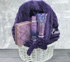 a basket filled with personal care items and a purple blanket on top of the basket