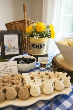 a table topped with lots of food next to a basket filled with flowers and other items