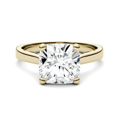 a yellow gold engagement ring with a cushion cut diamond