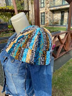 a mannequin's head is wrapped in a multicolored hat