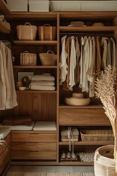 an organized closet with clothes and baskets