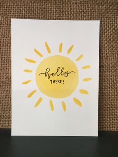 a card with the words hello there written in black ink on it, sitting on a table