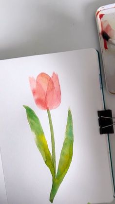 a watercolor painting of a pink tulip on a white paper with green leaves