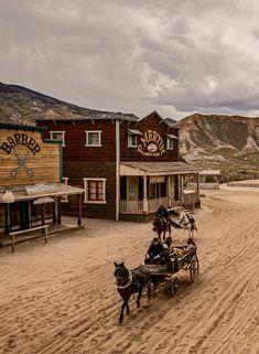 an old western town with horse drawn carriages