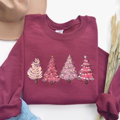 Christmas Tree Sweatshirt, Pink Tree Christmas Sweater, Christmas Sweater, Christmas Crewneck, Holiday Sweaters for Women, Winter Sweatshirt Christmas Tree Sweatshirt: Embrace the holiday spirit with this charming Christmas Tree Sweatshirt. Featuring a festive design, it's perfect for cozy nights by the fire or holiday gatherings. Ideal for any situation, a unisex heavy blend crewneck sweatshirt is pure comfort. These garments are made from polyester and cotton. This combination helps designs come out looking fresh and beautiful. The collar is ribbed knit, so it retains its shape even after washing. There are no itchy side seams on these sweaters.  .: Made with a medium-heavy fabric blend of 50% cotton and 50% polyester (8.0 oz/yd² (271.25 g/m this sweatshirt feels cozy and is the perfect Festive Holiday Cotton Sweater, Festive Holiday Crew Neck Sweatshirt, Festive Christmas Crew Neck Sweatshirt, Christmas Cotton Sweatshirt, Christmas Festive Cotton Sweatshirt, Festive Christmas Cotton Sweatshirt, Red Christmas Holiday Sweatshirt, Red Cotton Christmas Sweatshirt, Red Christmas Sweatshirt Gift