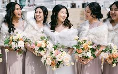 a group of women standing next to each other holding bouquets