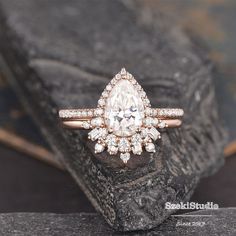 a diamond ring sitting on top of a rock