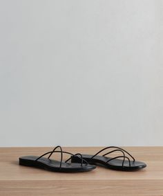 Eve Sandal Black Minimalist, effortless, and refined this strappy sandal is an instant seasonal staple. Nappa Leather. Made in Spain. Flat strappy sandal. Black Minimalist, Strappy Sandals Flat, Strappy Flats, Jenni Kayne, Cardigan Sweater Coat, Mule Sandals, Flat Boots, Slipper Boots, Cool Socks