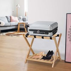 a suitcase sitting on top of a wooden stand next to a shoe rack in a living room