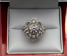 a diamond ring in a red box with white trimmings on the bottom and sides