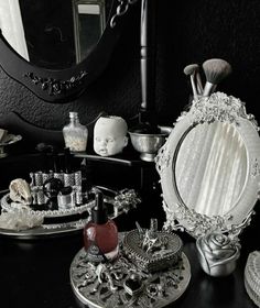 there is a mirror and other decorative items on the table in front of the mirror