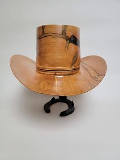 Beautiful wood-turned hat made from Ambrosia Maple signed and numbered by the artist, Brian Butler. Make a fashion statement in this unique hat! Measurements: Inside circumference: 22 inches Bill: 17.25" x 15" Height: 6.5" Weight: 3 lbs. ﻿Hatband and stand available for purchase separately. Artisan Brown Top Hat For Kentucky Derby, Artisan Top Hat For Kentucky Derby And Western-themed Events, Artisan Top Hat With Curved Brim For Western-themed Events, Unique Hats, Hat Band, Cowboy Hat, Hat Making, Fashion Statement, Cowboy Hats