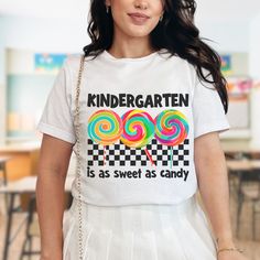 Bella + Canvas "Second Grade is as Sweet as Candy" T-Shirt - Perfect for Kindergarten Teachers 🍭 Sweeten your back-to-school wardrobe with our adorable Bella + Canvas "Kindergarten is as Sweet as Candy" T-Shirt! 🍭 Designed especially for first grade teachers, this delightful t-shirt features a vibrant and playful design that perfectly captures the joy and sweetness of teaching young learners. Whether you're preparing for the first day of school or looking for the perfect gift for a fellow teac Cute White T-shirt For End Of School Year, Sweet White T-shirt With Graphic Print, Playful White T-shirt With Funny Text, White Sweet T-shirt With Funny Print, Sweet White T-shirt With Funny Print, White T-shirt With Funny Text For Teacher Appreciation, First Grade Teachers, Teacher Tees, Kindergarten Teachers