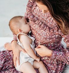 a woman holding a baby in her arms